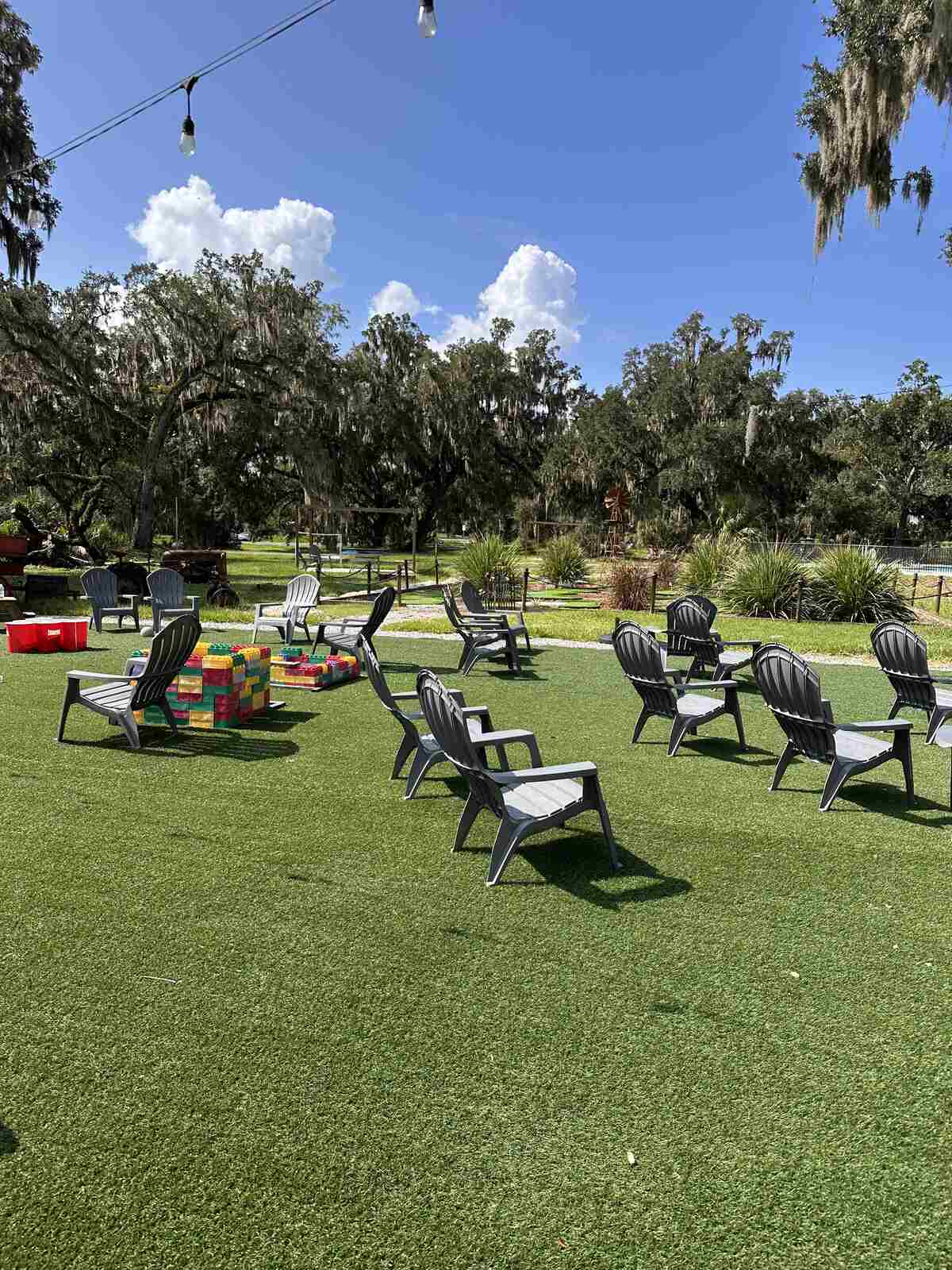 Adirondack chairs facing the outdoor movie screen at Peace River Oaks, Bowling Green, Florida