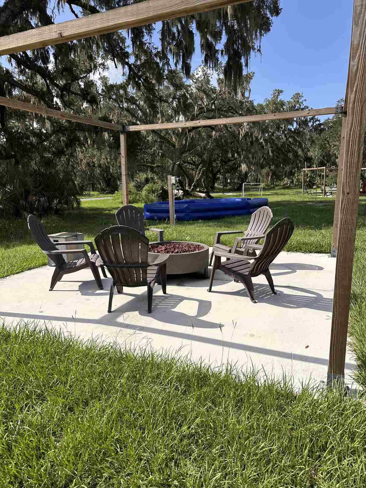 Fire pit and seating under the pergola at Peace River Oaks, Bowling Green, Florida