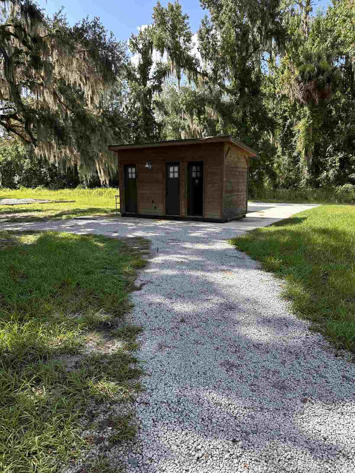 The detached private bathroom building for a glamping tent at Peace River Oaks, Bowling Green, Florida