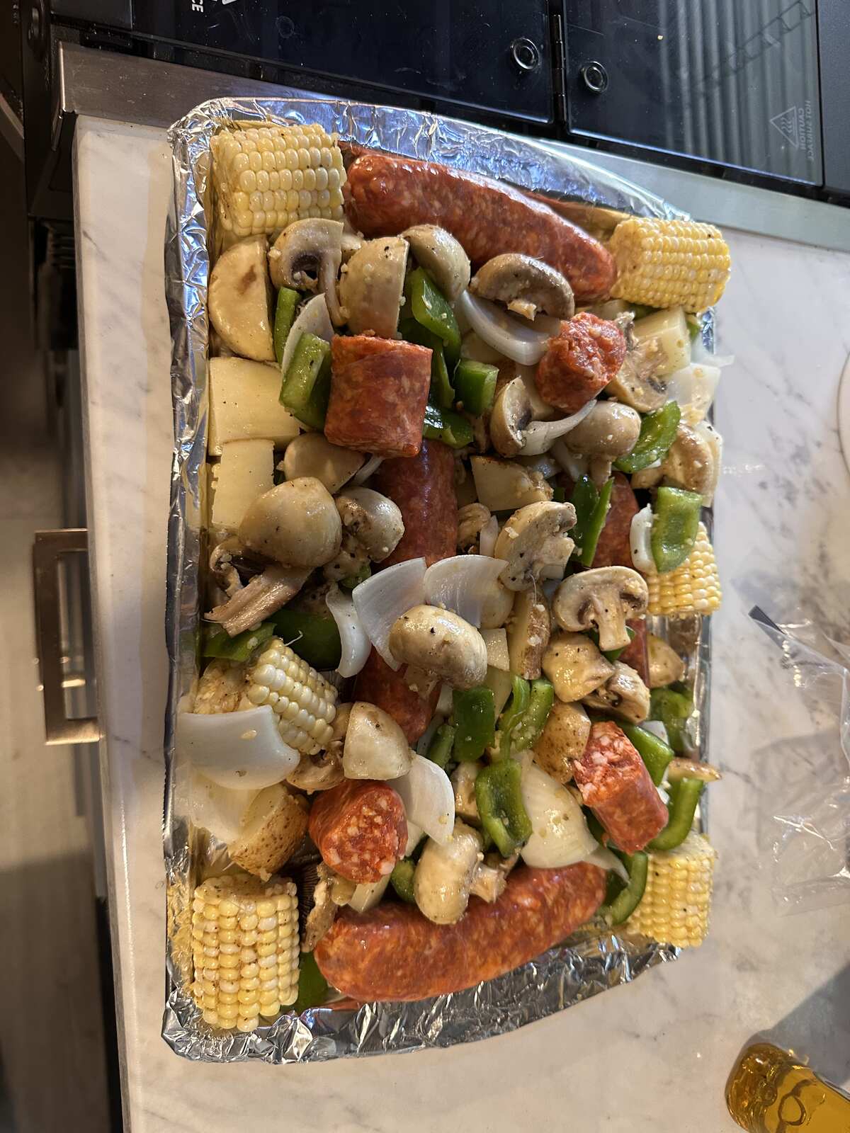 A sheet pan dinner of sausage, corn and peppers we cooked at our site at Peace River Oaks, Bowling Green, Florida