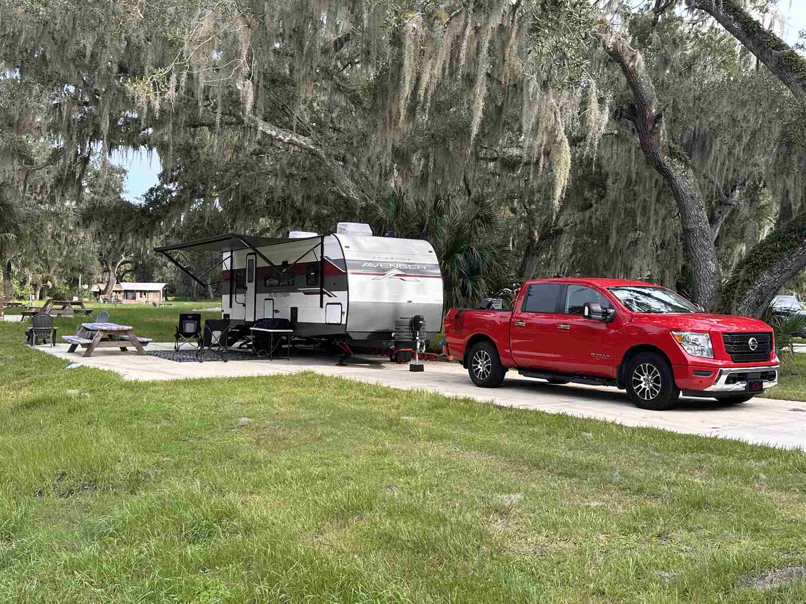 Our travel trailer and truck under the live oaks on site 56 at Peace River Oaks, a Peace River campground, Florida