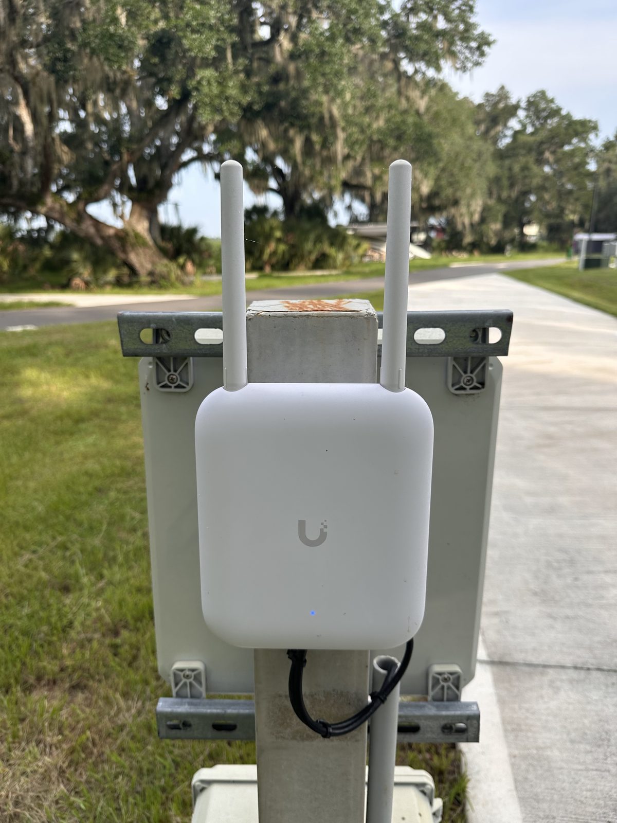 The Ubiquiti UniFi WiFi access point mounted on the utility pedestal at our site at Peace River Oaks, Bowling Green, Florida